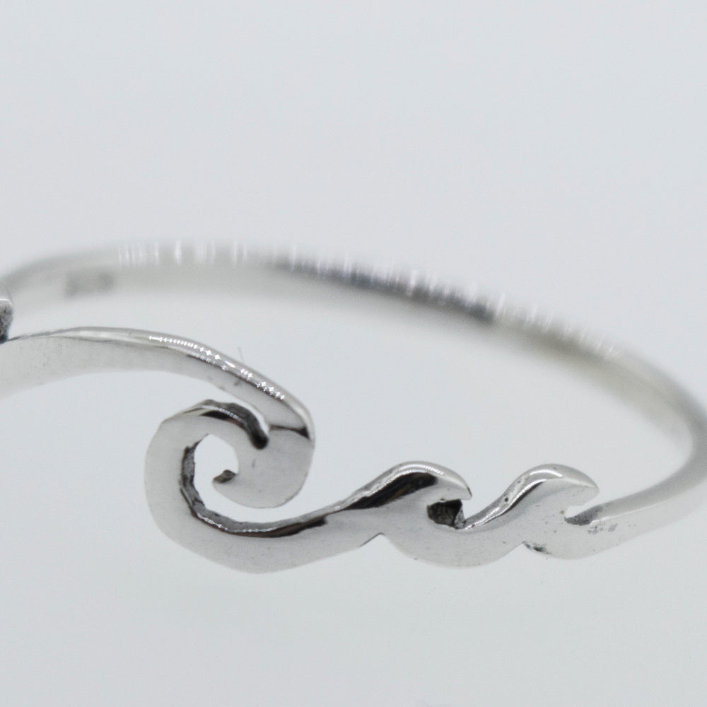 A modern sterling silver Wave Ring with a minimalist wave design.
