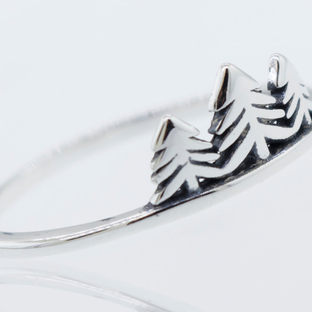 
                  
                    A minimalist silver Trees ring with delicate tree engravings, inspired by nature.
                  
                