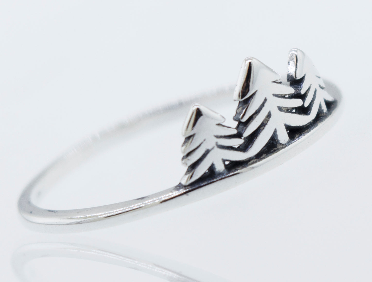 
                  
                    A minimalist silver Trees ring with delicate tree engravings, inspired by nature.
                  
                