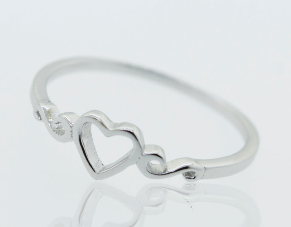 A Simple Open Heart Ring on a white surface.