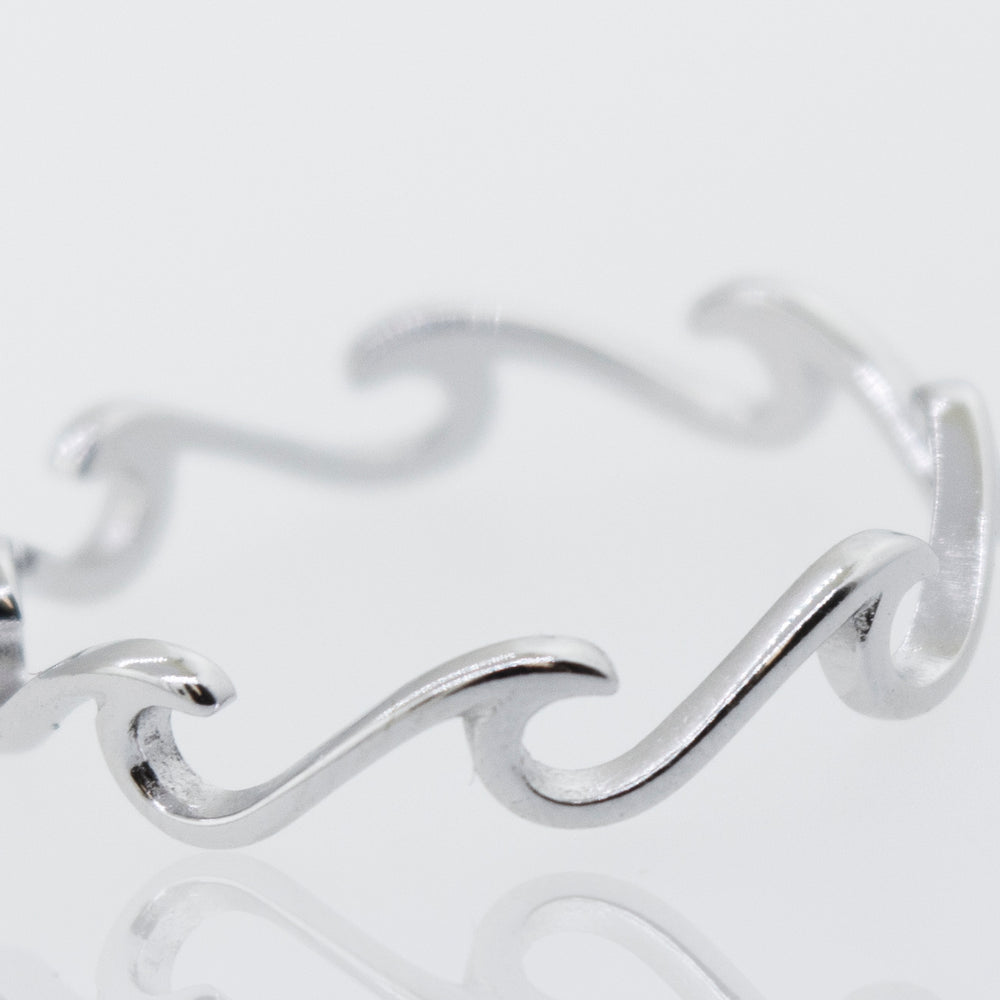 A minimalist and modern Wave Ring with waves on it.