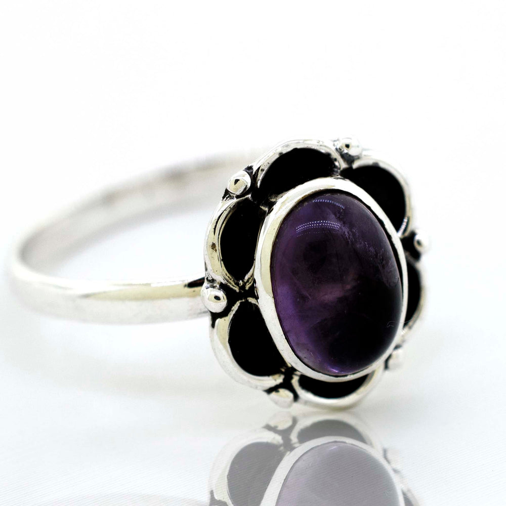
                  
                    Delicate Super Silver sterling silver Gemstone Ring With Oxidized Flower Design featuring a central amethyst gemstone.
                  
                