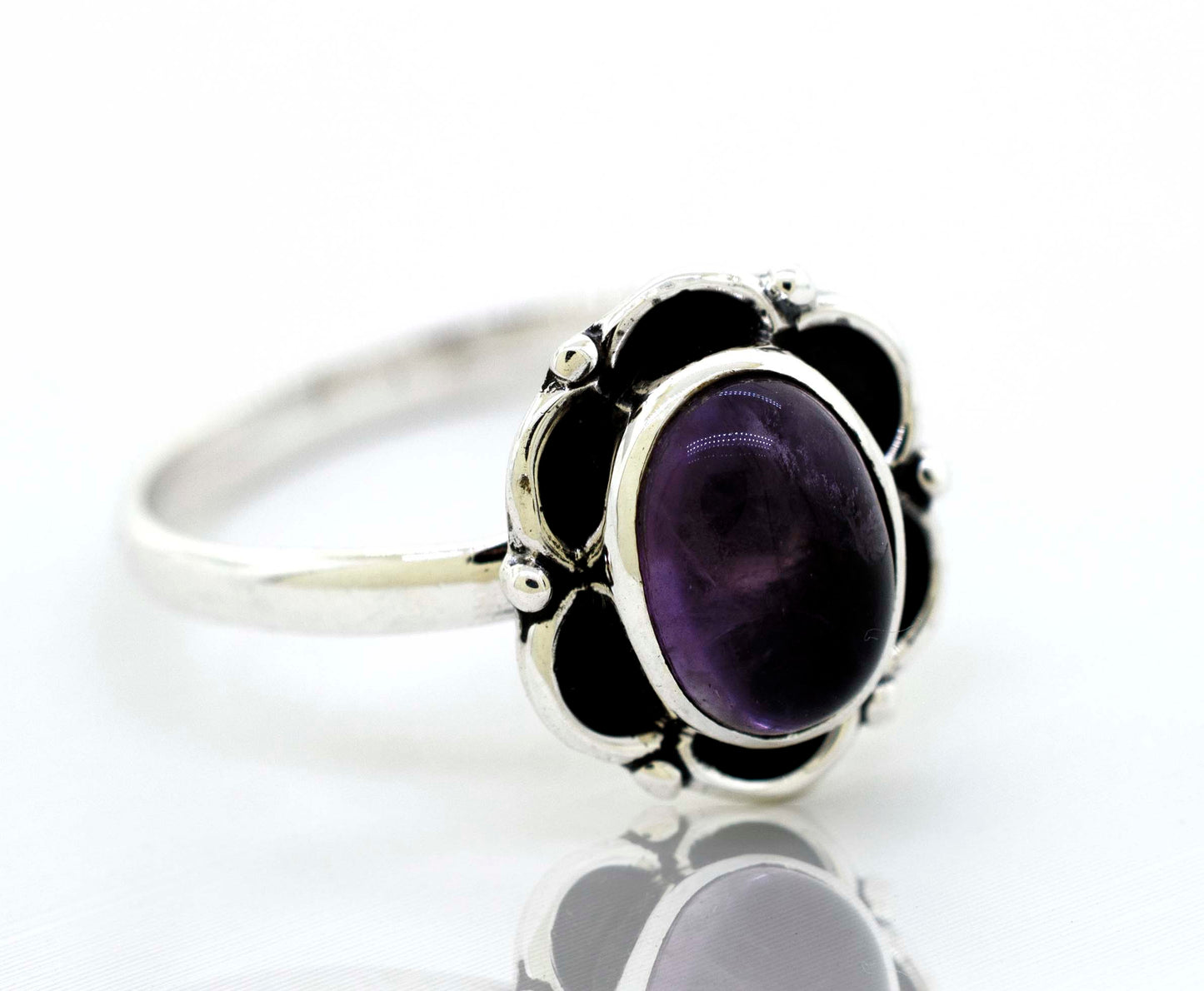 
                  
                    Delicate Super Silver sterling silver Gemstone Ring With Oxidized Flower Design featuring a central amethyst gemstone.
                  
                