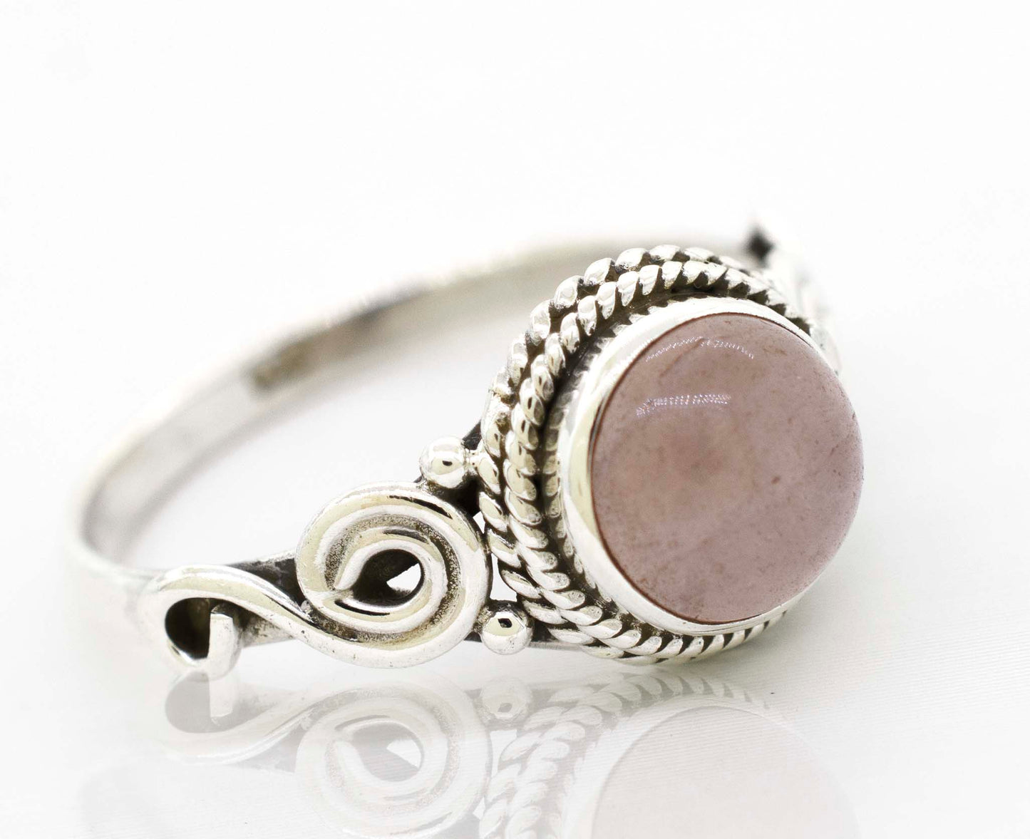 
                  
                    A Super Silver Gemstone Circle Ring With Rope Border And Swirl Design with a pink gemstone.
                  
                