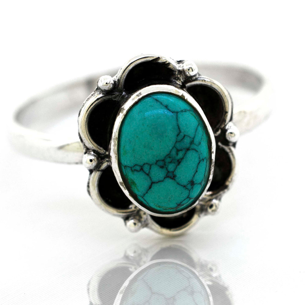 
                  
                    A delicate Super Silver gemstone ring with a central turquoise gemstone embraced by silver petals.
                  
                