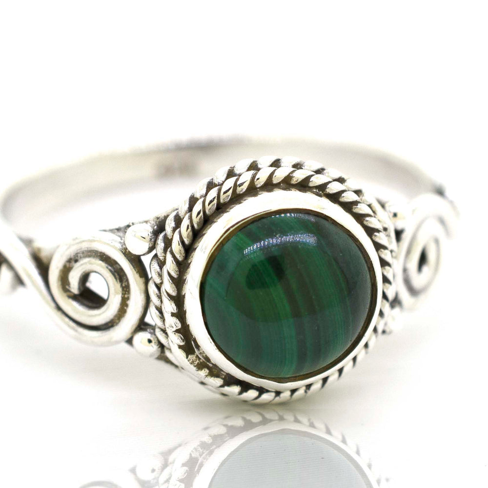 
                  
                    A Gemstone Circle Ring With Rope Border And Swirl Design, radiating a bohemian vibe.
                  
                