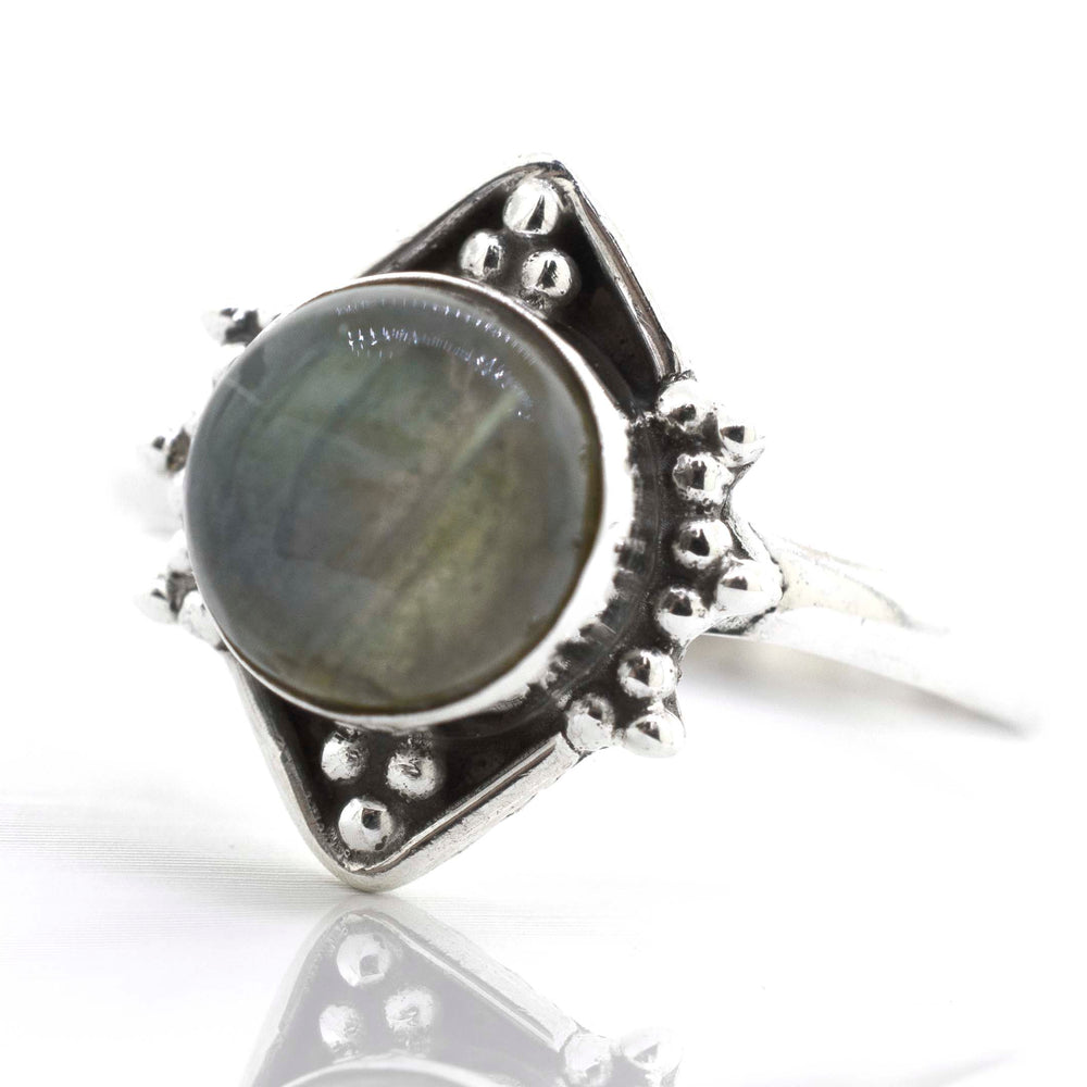 
                  
                    A Super Silver Round Gemstone Ring With Oxidized Diamond Shape Pattern adorned with a mesmerizing labradorite gemstone.
                  
                