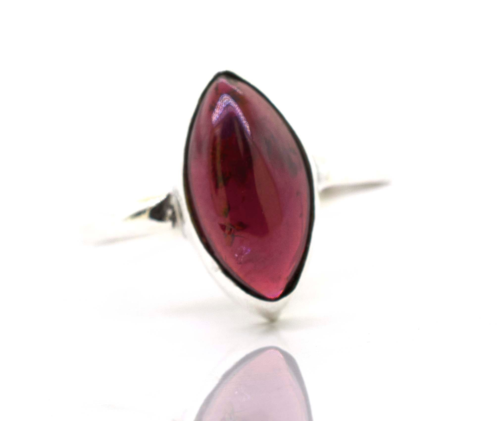 A Super Silver Simple Marquise Shaped Gemstone Ring with a pink gemstone in the middle.