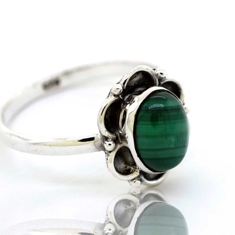 
                  
                    A delicate Gemstone Ring With Oxidized Flower Design by Super Silver with a central green malachite gemstone and silver petals.
                  
                