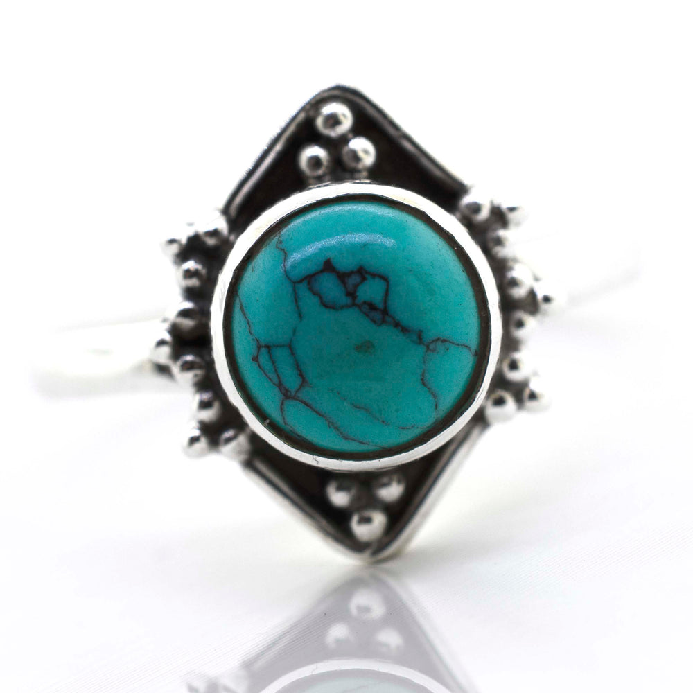 
                  
                    A Super Silver round gemstone ring with oxidized diamond shape pattern set with a stunning turquoise gemstone.
                  
                