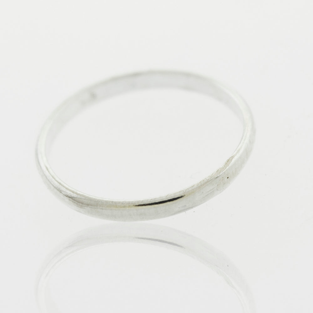 
                  
                    A Light Weight Simple Bands silver ring with simple bands on a white surface.
                  
                