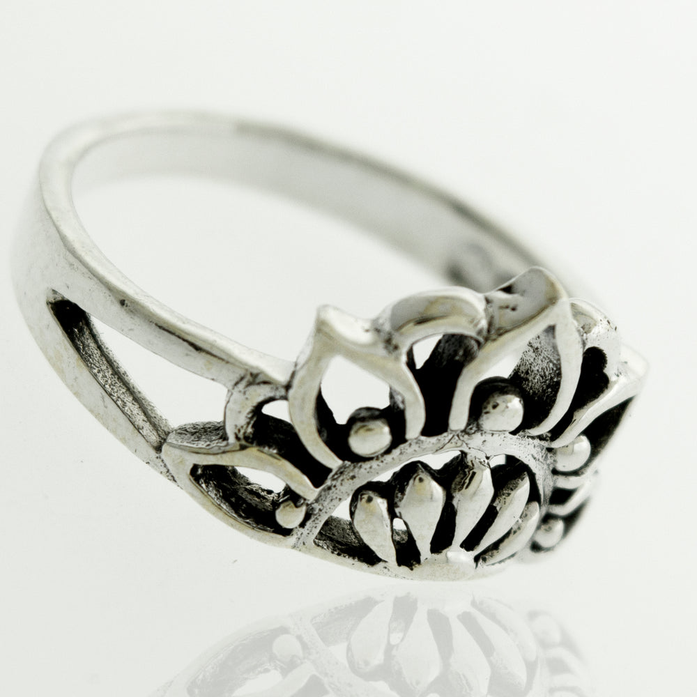 A silver Half Mandala Ring adorned with a lotus flower.