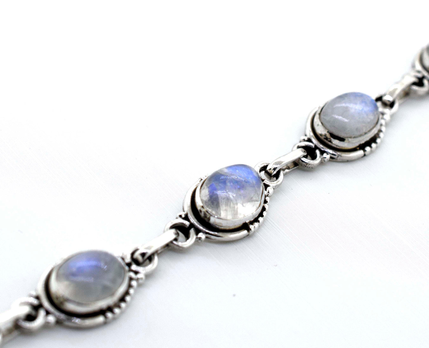 
                  
                    A "Super Silver Oval Gemstone Bracelet With Half Ball Border" adorned with moonstones, a captivating gemstone.
                  
                