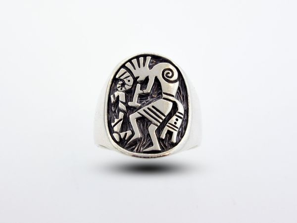 A Super Silver Western Inspired Kokopelli Ring Thick Band with an image of Kokopelli, a fertility deity, riding a horse.