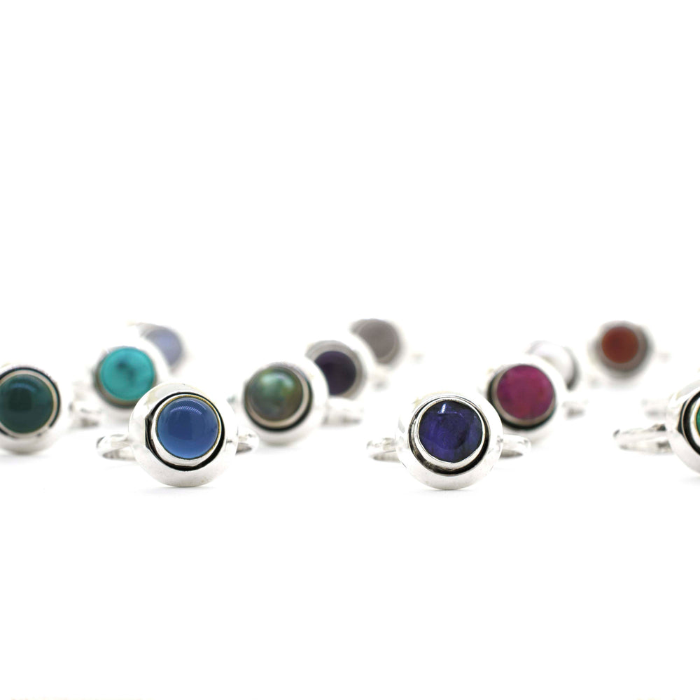 
                  
                    A group of Round Gemstone Rings With Oxidized Outline with a boho vibe on a white background.
                  
                
