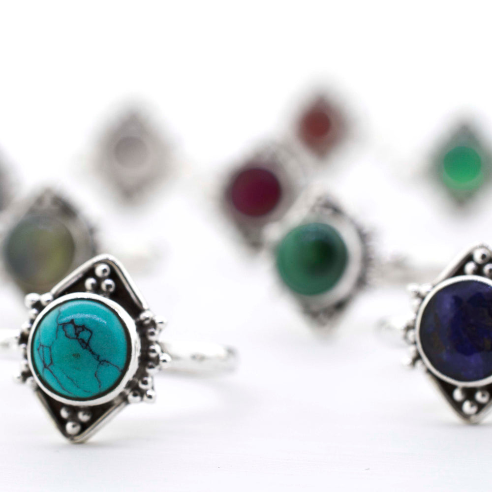
                  
                    A group of Round Gemstone Rings With Oxidized Diamond Shape Pattern on a white surface, including sterling silver.
                  
                