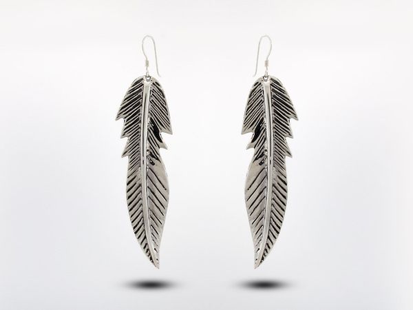 Handmade Super Silver Medium Native American Made Feather Earrings on a white background with a Native American touch.