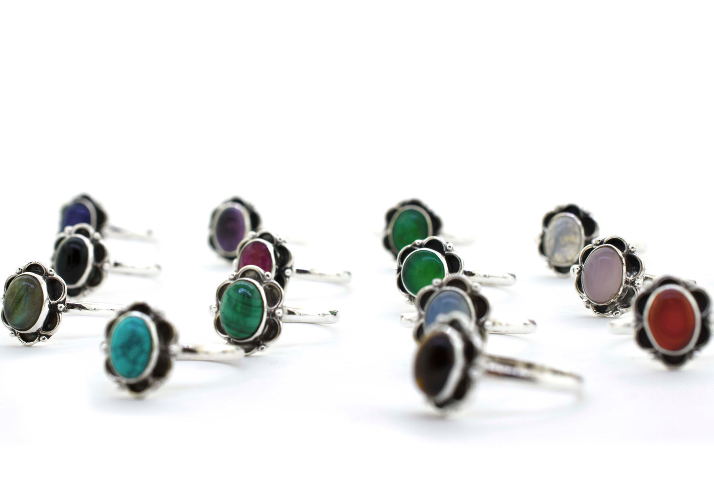 
                  
                    A group of Gemstone Rings With Oxidized Flower Design on a white background.
                  
                