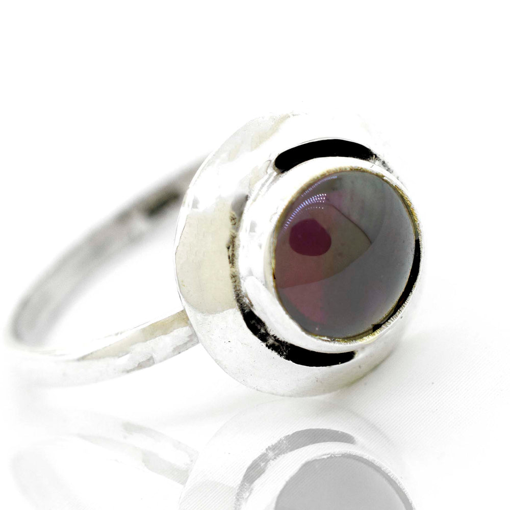 
                  
                    A contemporary Round Gemstone Ring With Oxidized Outline from Super Silver, featuring a silver band and a vibrant red stone.
                  
                