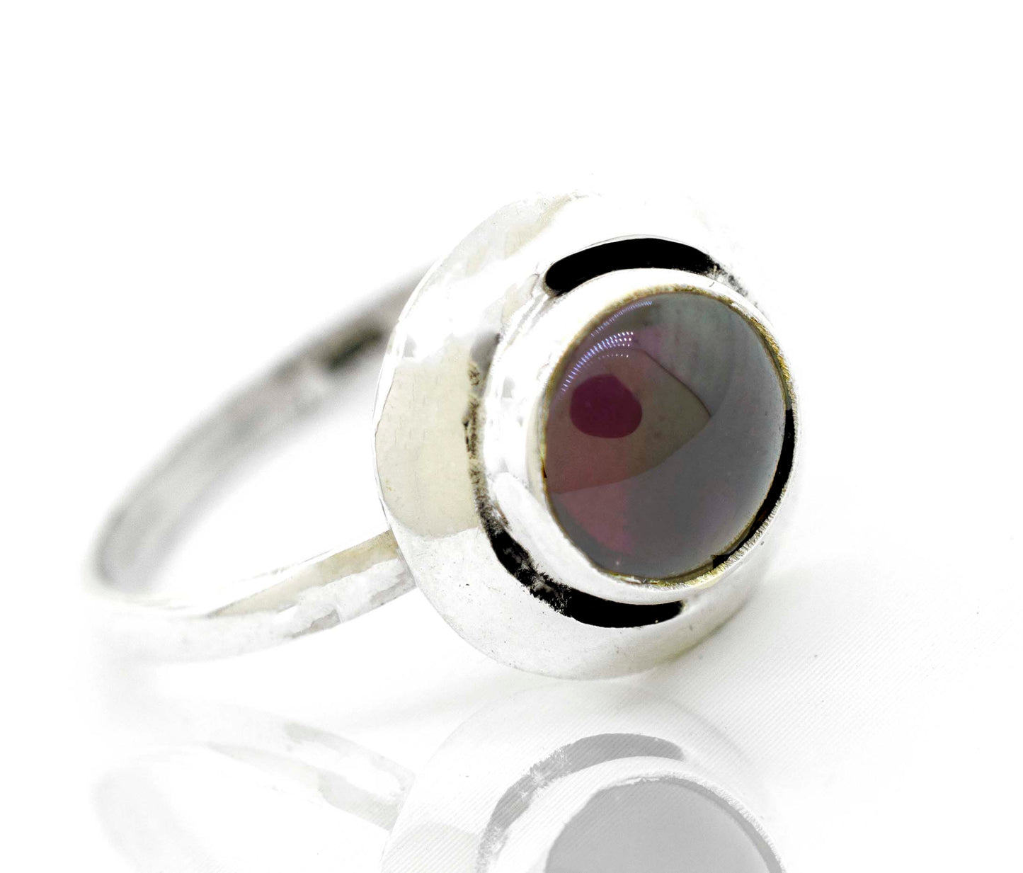 
                  
                    A contemporary Round Gemstone Ring With Oxidized Outline from Super Silver, featuring a silver band and a vibrant red stone.
                  
                