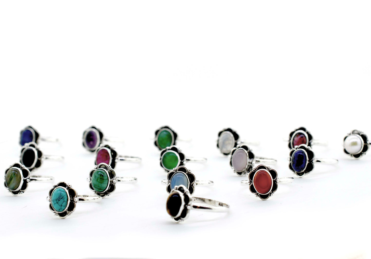 
                  
                    A group of colorful Gemstone Rings With Oxidized Flower Design on a white background.
                  
                
