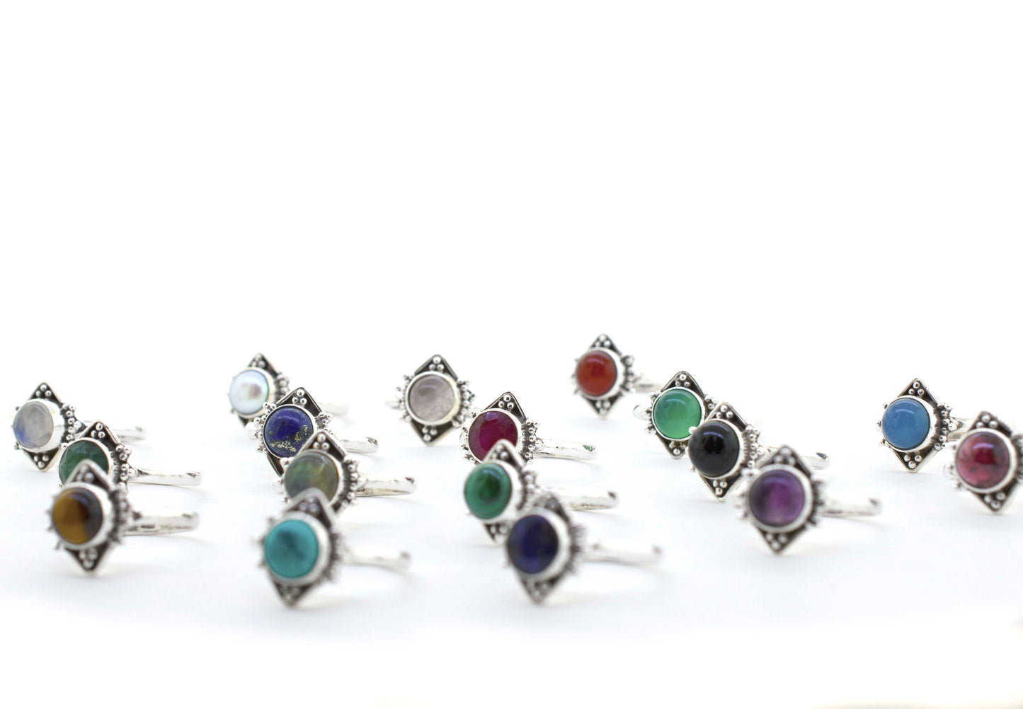 
                  
                    An eclectic display of Round Gemstone Rings With Oxidized Diamond Shape Pattern on a white background.
                  
                
