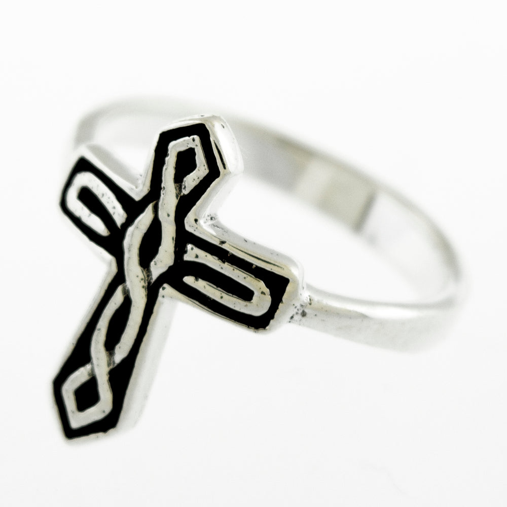 
                  
                    A Super Silver Cross Ring With Celtic Weave with a darkened finish and intricate black and white designs inspired by Celtic weave.
                  
                