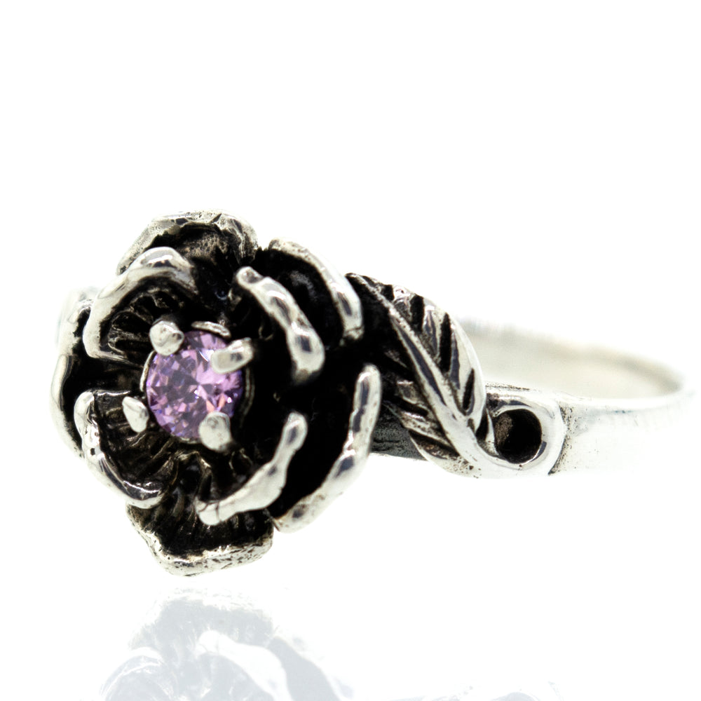 A sterling silver rose ring adorned with a pink CZ stone, inspired by the beauty of nature.