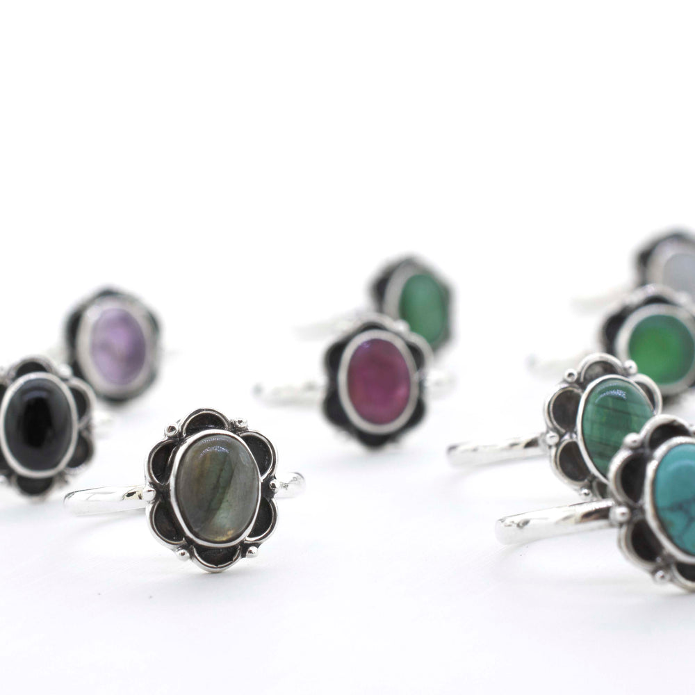
                  
                    A group of Gemstone Rings With Oxidized Flower Design, inspired by the vibrant colors of Santa Cruz.
                  
                