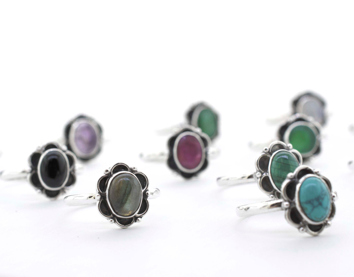 
                  
                    A group of Gemstone Rings With Oxidized Flower Design, inspired by the vibrant colors of Santa Cruz.
                  
                