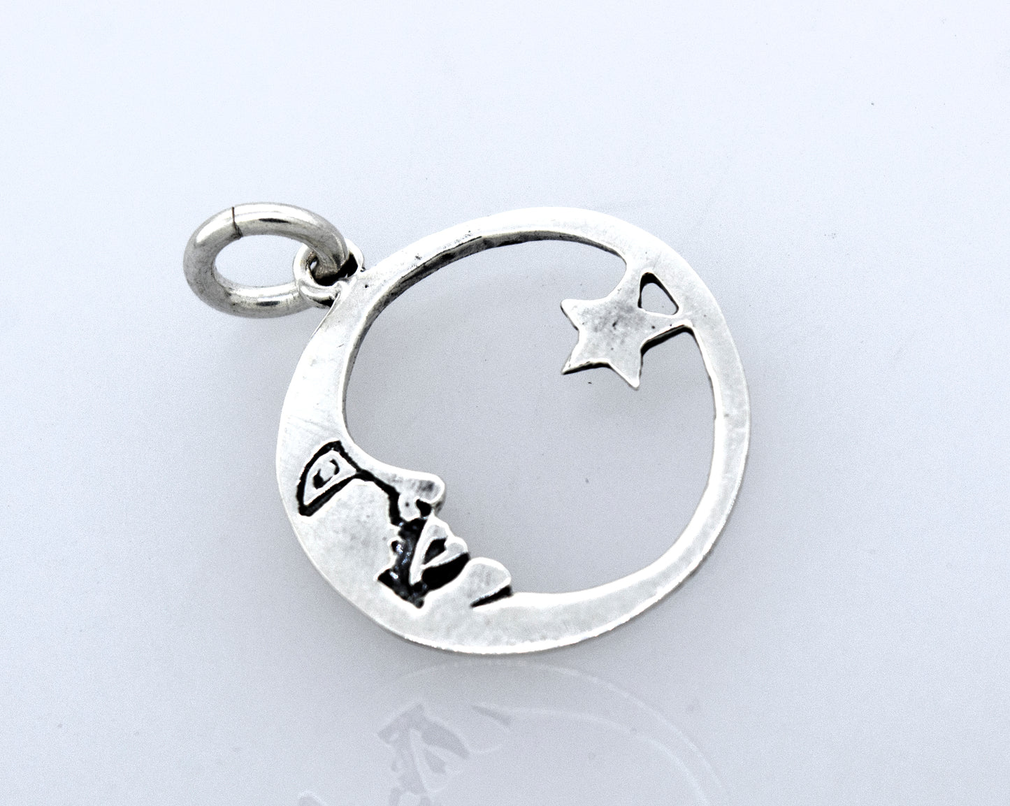 
                  
                    A celestial-style Crescent and Star Pendant with a moon and stars on it from Super Silver.
                  
                