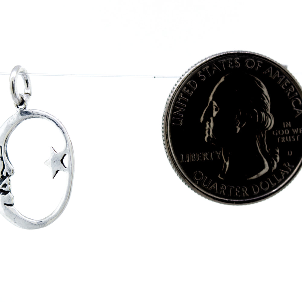 
                  
                    A Super Silver Crescent and Star Pendant featuring a silver charm with a face on it, accompanied by a dime.
                  
                