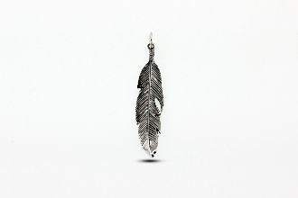 
                  
                    A Super Silver small feather pendant gracefully hangs on a white background.
                  
                