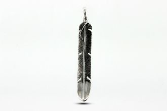 A Long Rustic Feather Pendant by Super Silver, crafted from .925 sterling silver, hanging on a white background.