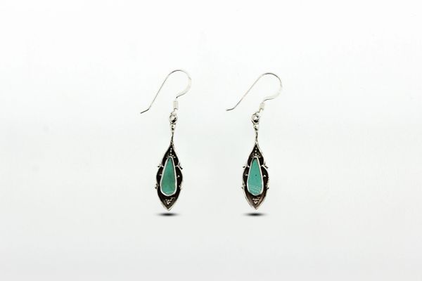 A pair of Ornate Turquoise Dangle Earrings with Blackened Silver Border made by Super Silver.
