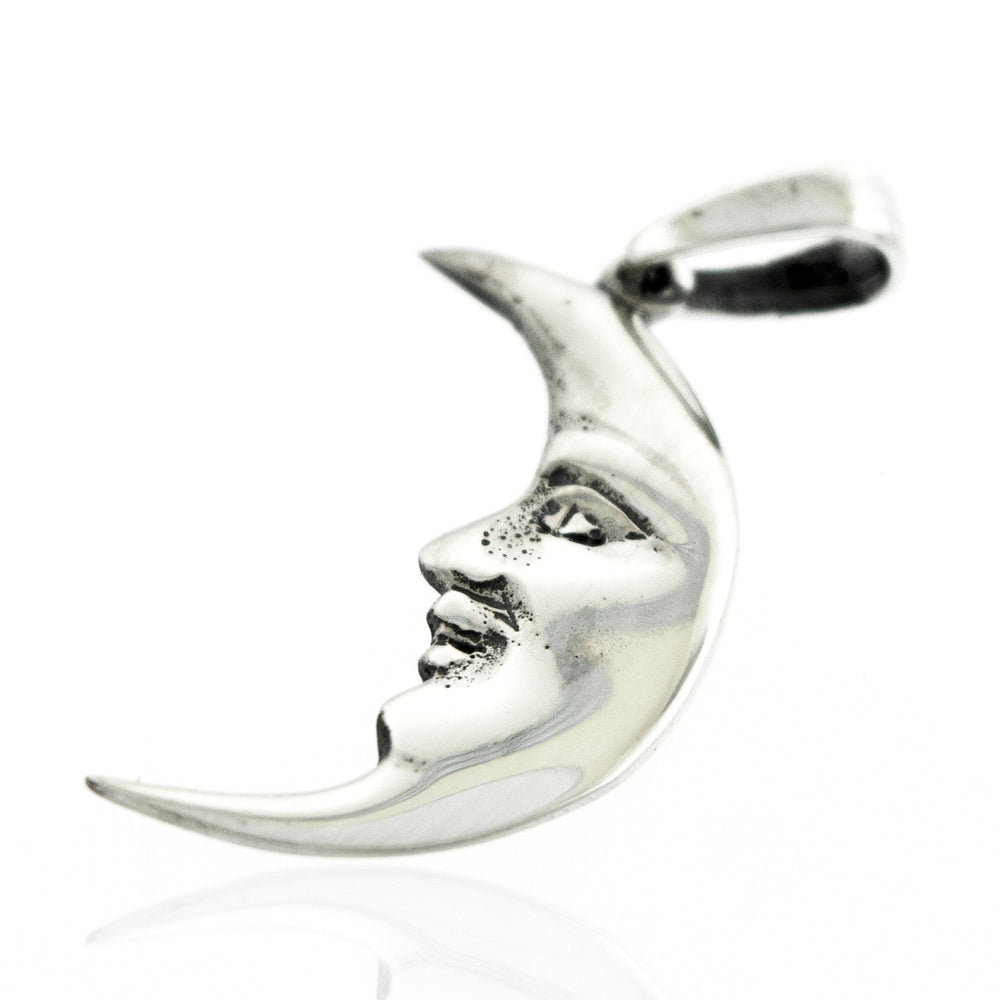 A Super Silver Crescent Man In The Moon Pendant with a face on it.