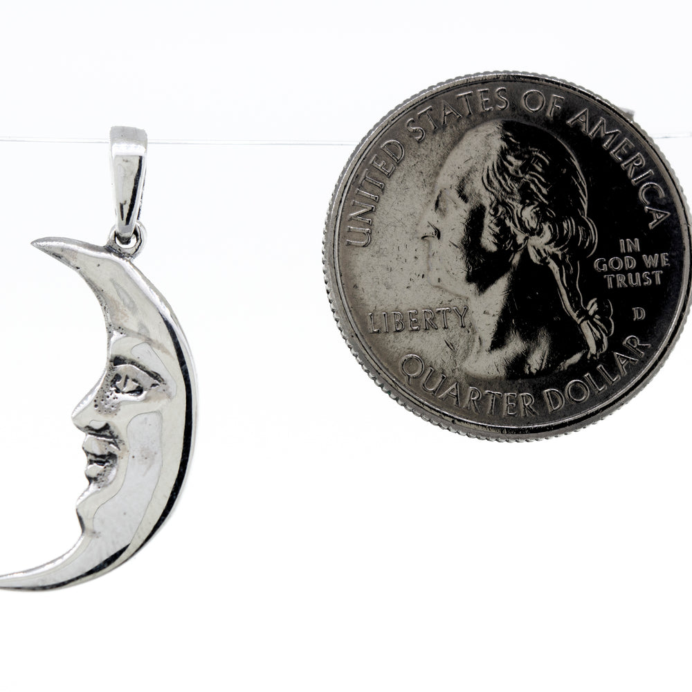 
                  
                    A Super Silver Crescent Man In The Moon Pendant, depicting an elegant moon, accompanied by a delicate coin.
                  
                