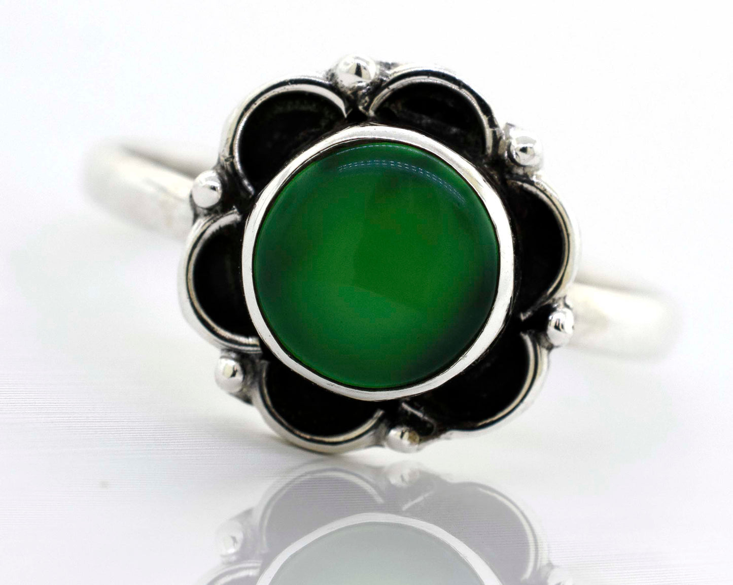 
                  
                    A Gemstone Ring With Oxidized Flower Design with a green stone and black stones.
                  
                