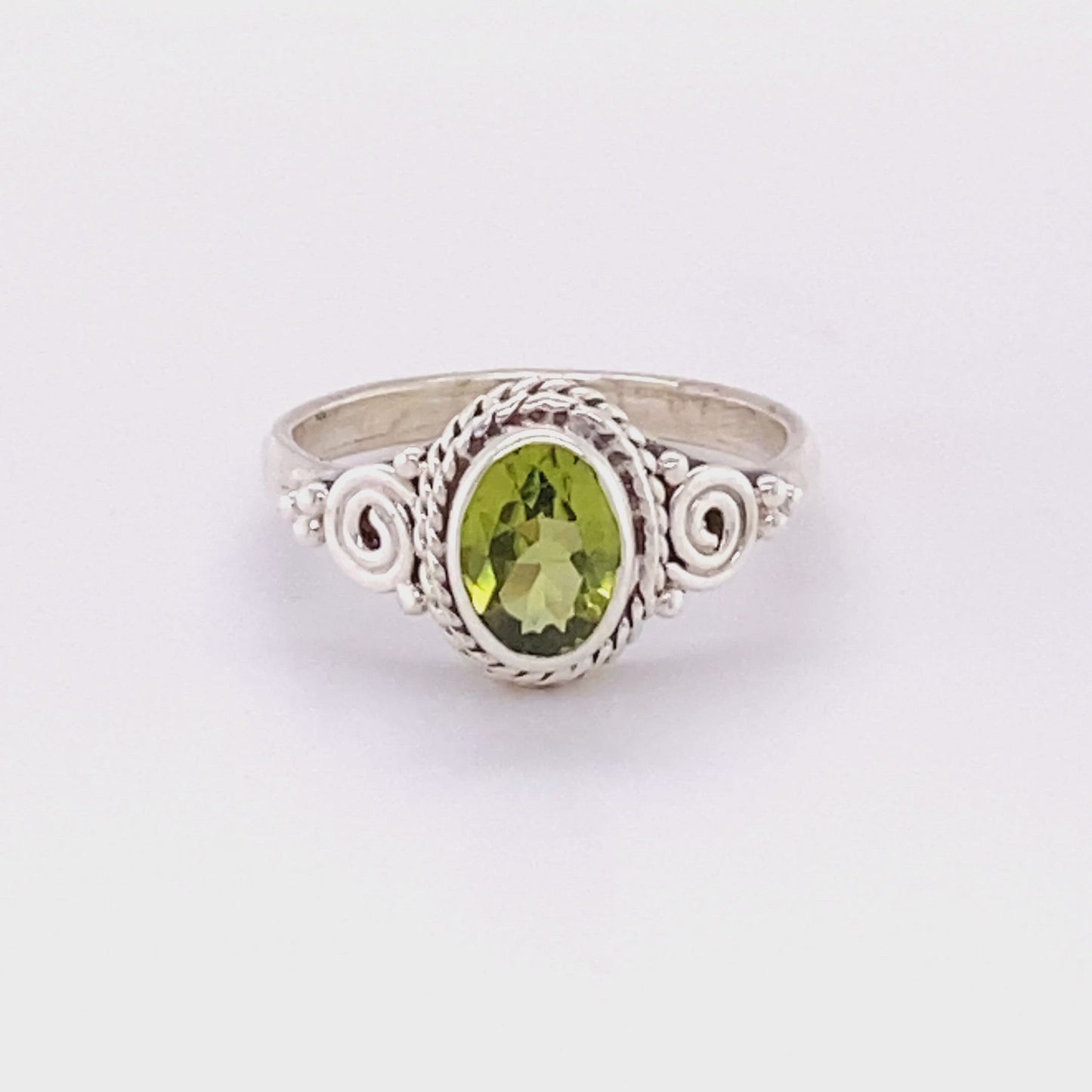 
                  
                    Load and play video in Gallery viewer, Oval Peridot Ring with Intricate Rope and Spiral Border
                  
                