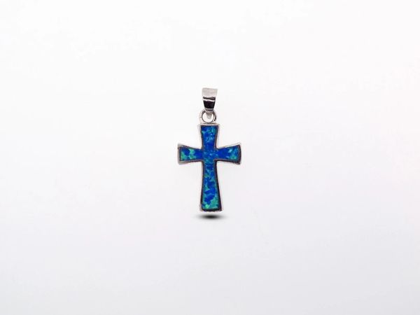 A fiery Super Silver Blue Opal Cross Pendant on a white background, made with sterling silver.