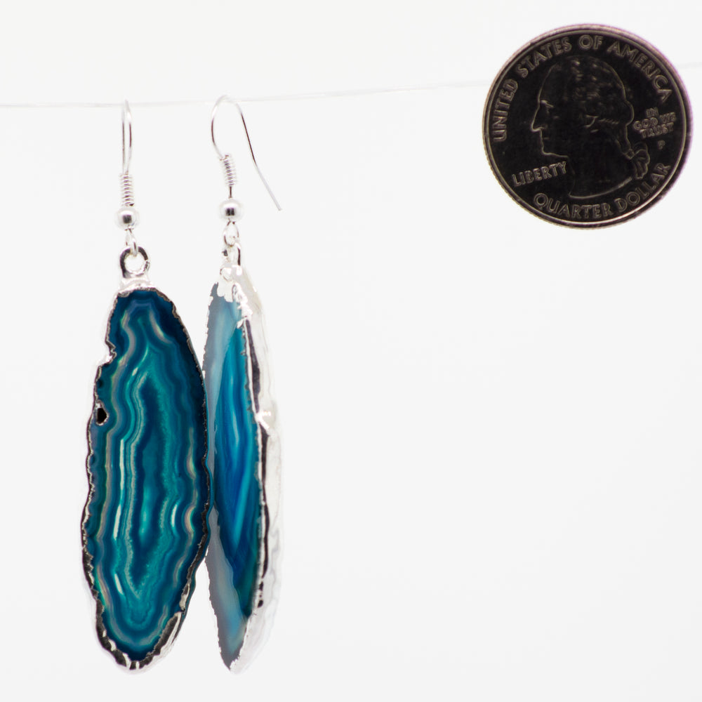 
                  
                    Various colors of Super Silver's Dyed Agate Slice earrings with a silver-plated border.
                  
                