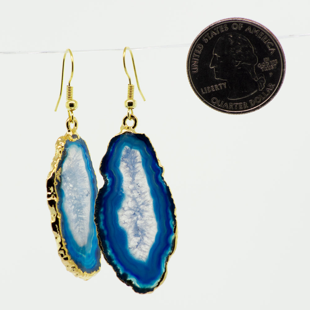 A pair of Super Silver Gold Agate Slice Earrings, featuring a stunning blue slice of stone.