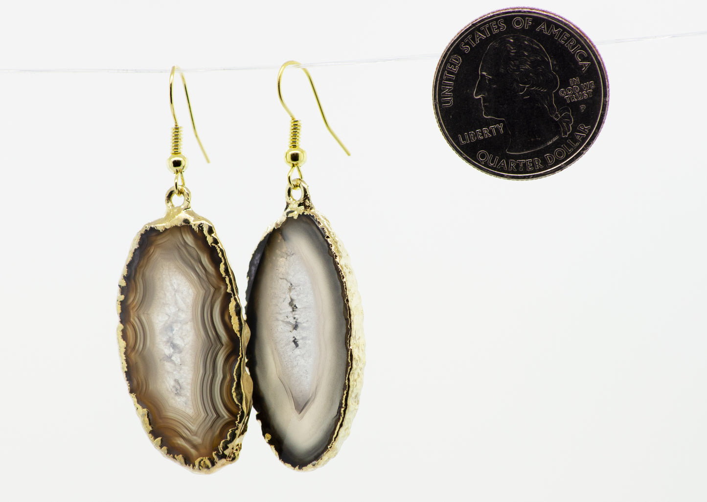 
                  
                    An elegant pair of Super Silver Gold Agate Slice Earrings featuring a unique coin accent.
                  
                