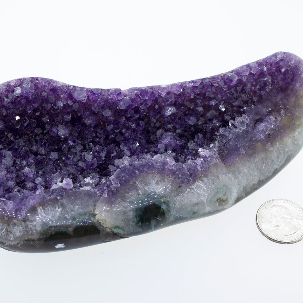 
                  
                    An Oval Shaped Amethyst Geode decor next to a dime.
                  
                