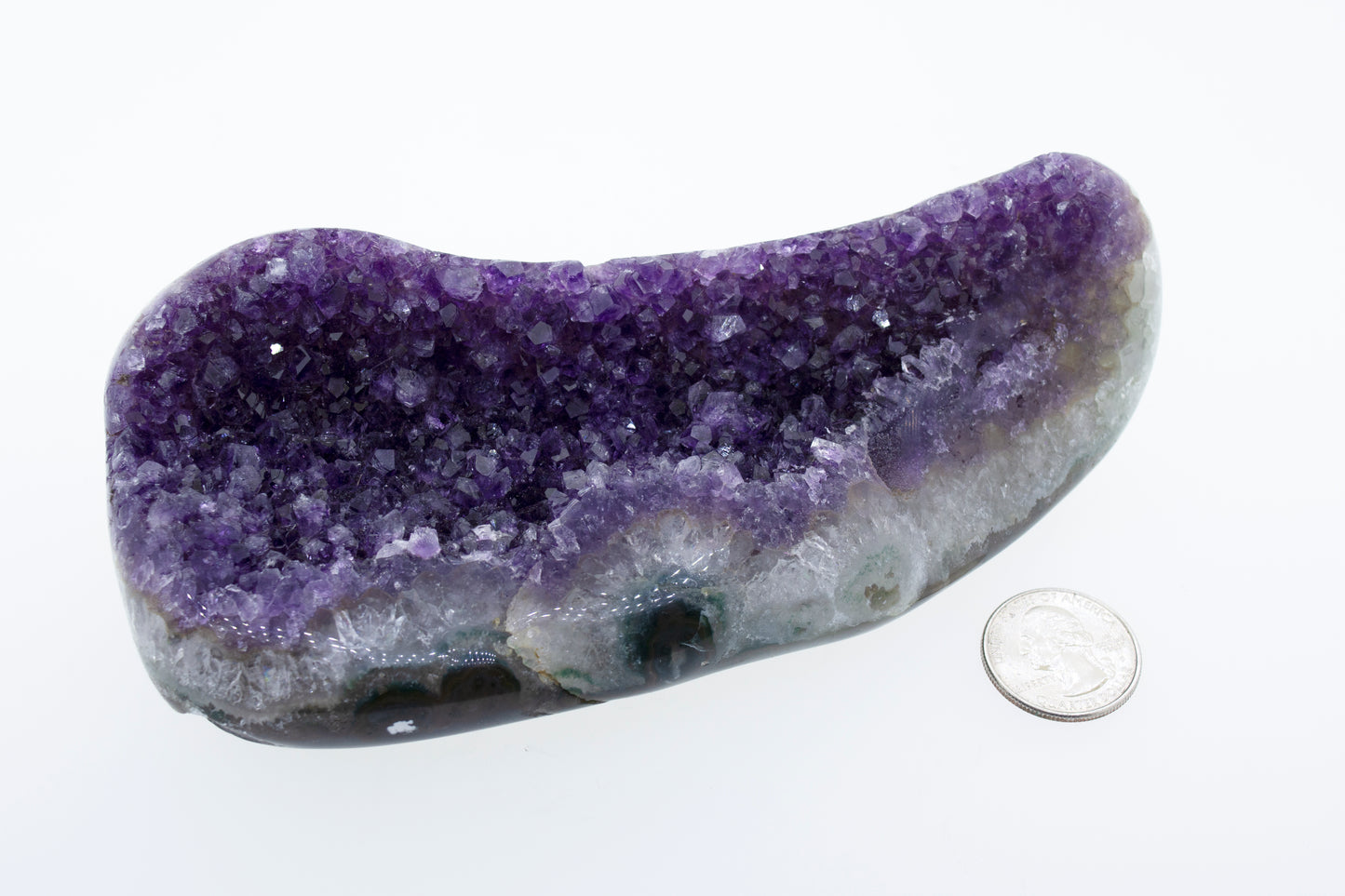 
                  
                    An Oval Shaped Amethyst Geode decor next to a dime.
                  
                