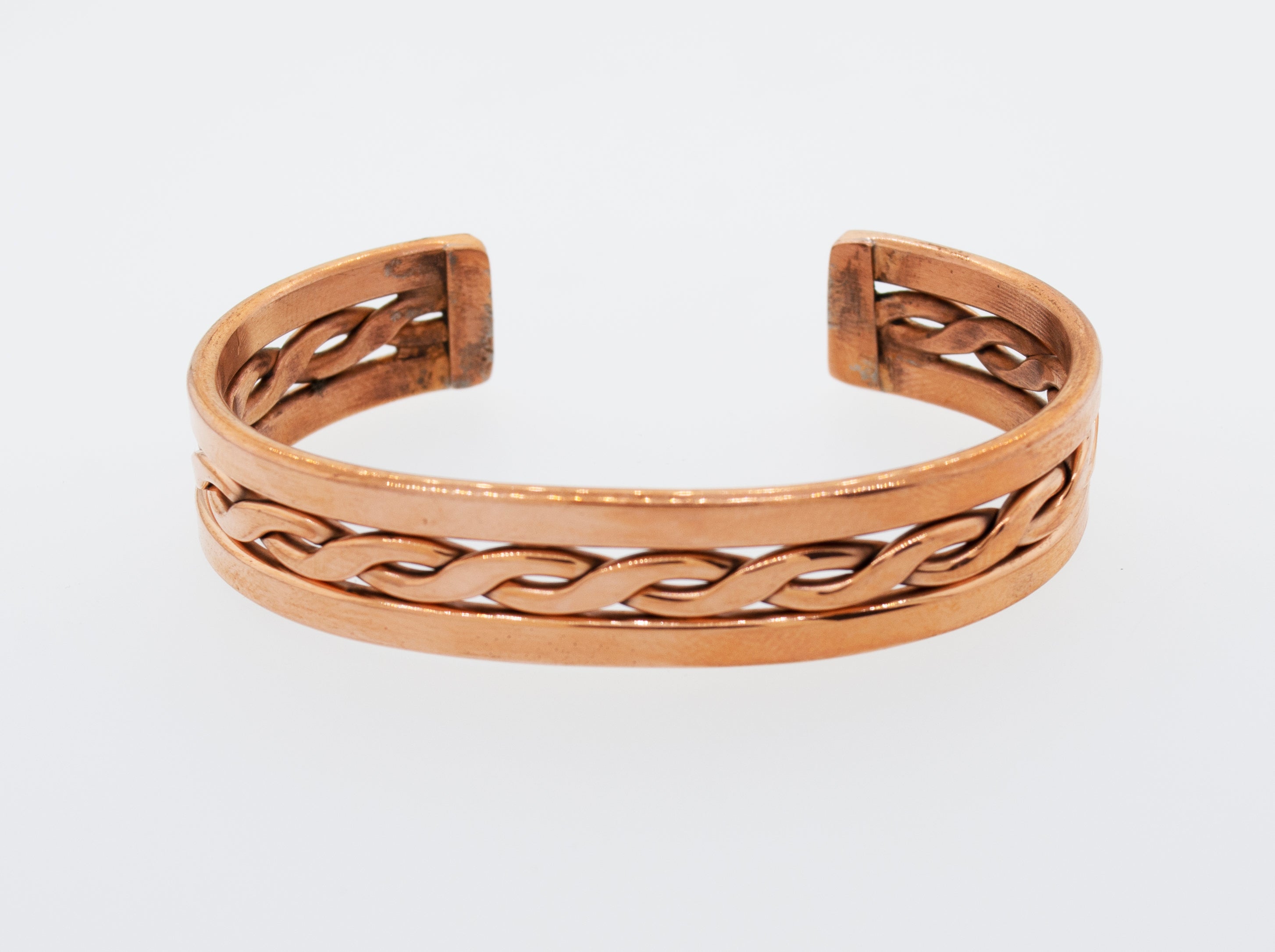 A Super Silver handmade copper cuff bracelet with a braided design, crafted in the style of Native American jewelry.