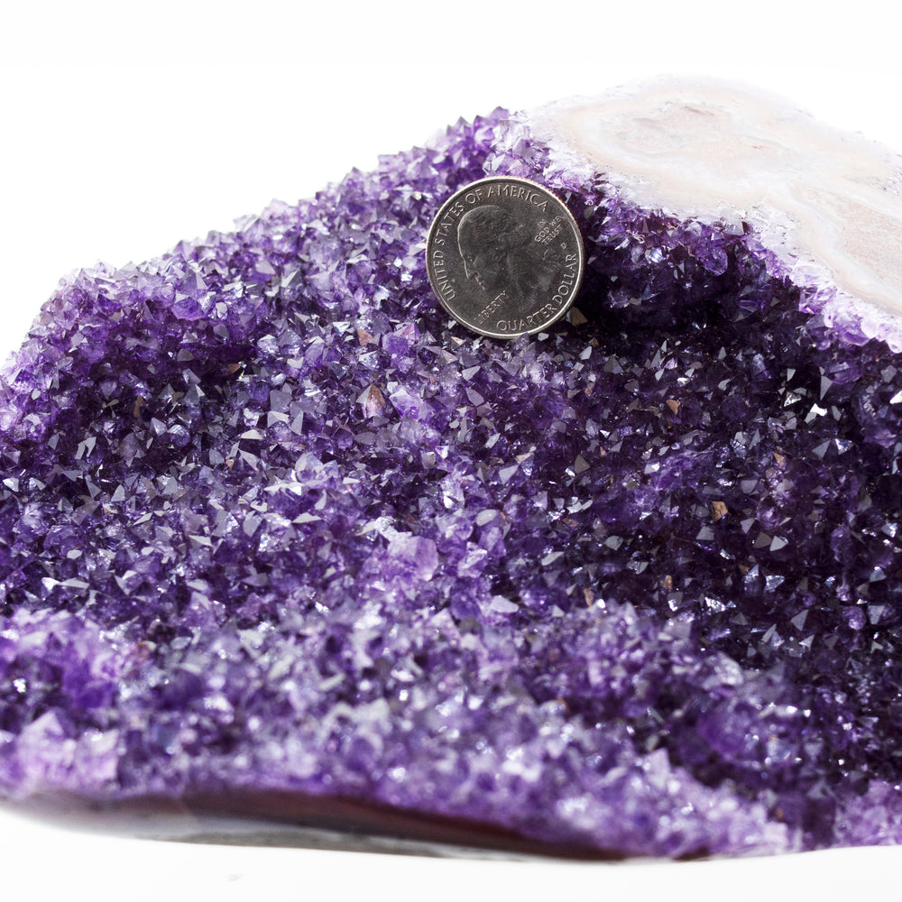 
                  
                    A decorative Beautiful Freeform Amethyst Geode with a coin on top.
                  
                