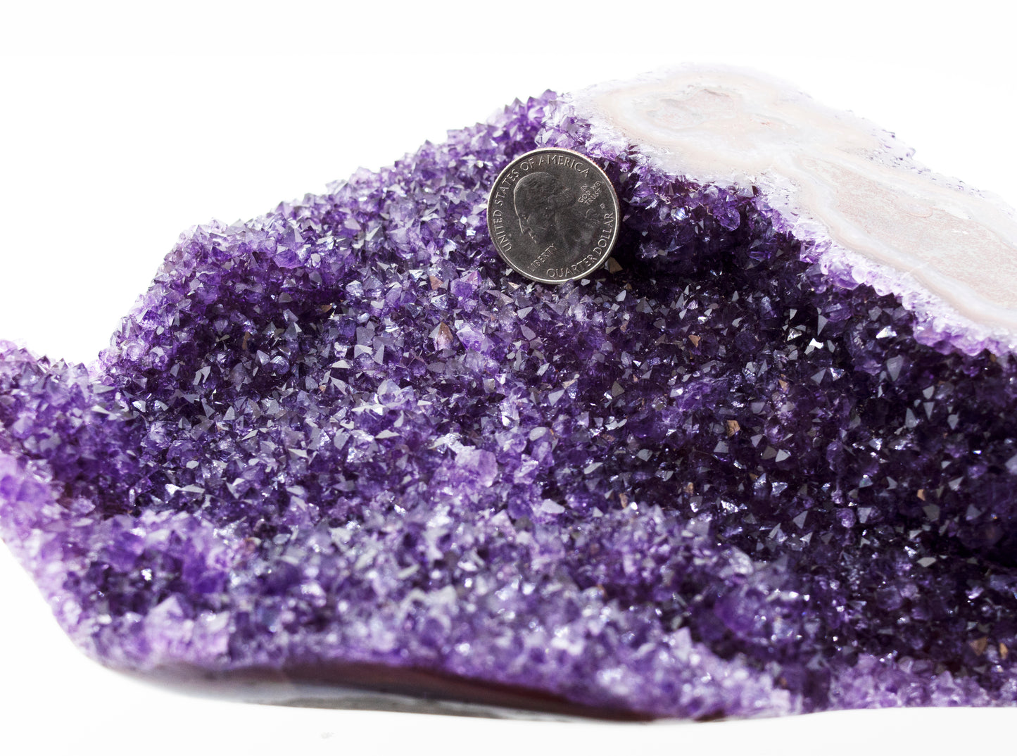
                  
                    A decorative Beautiful Freeform Amethyst Geode with a coin on top.
                  
                