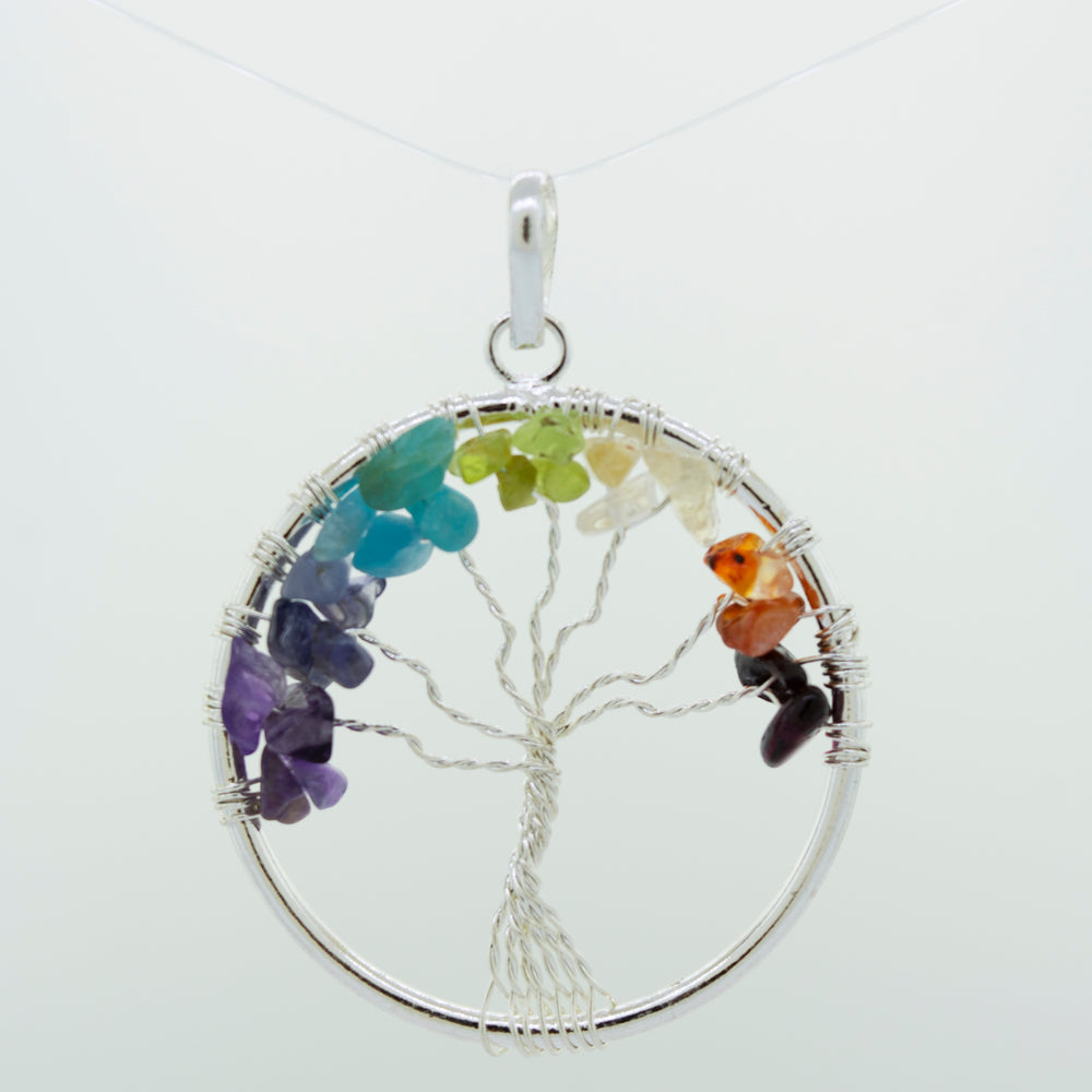 
                  
                    A Super Silver Wire-Wrapped Chakra Tree of Life pendant adorned with chakra stones.
                  
                