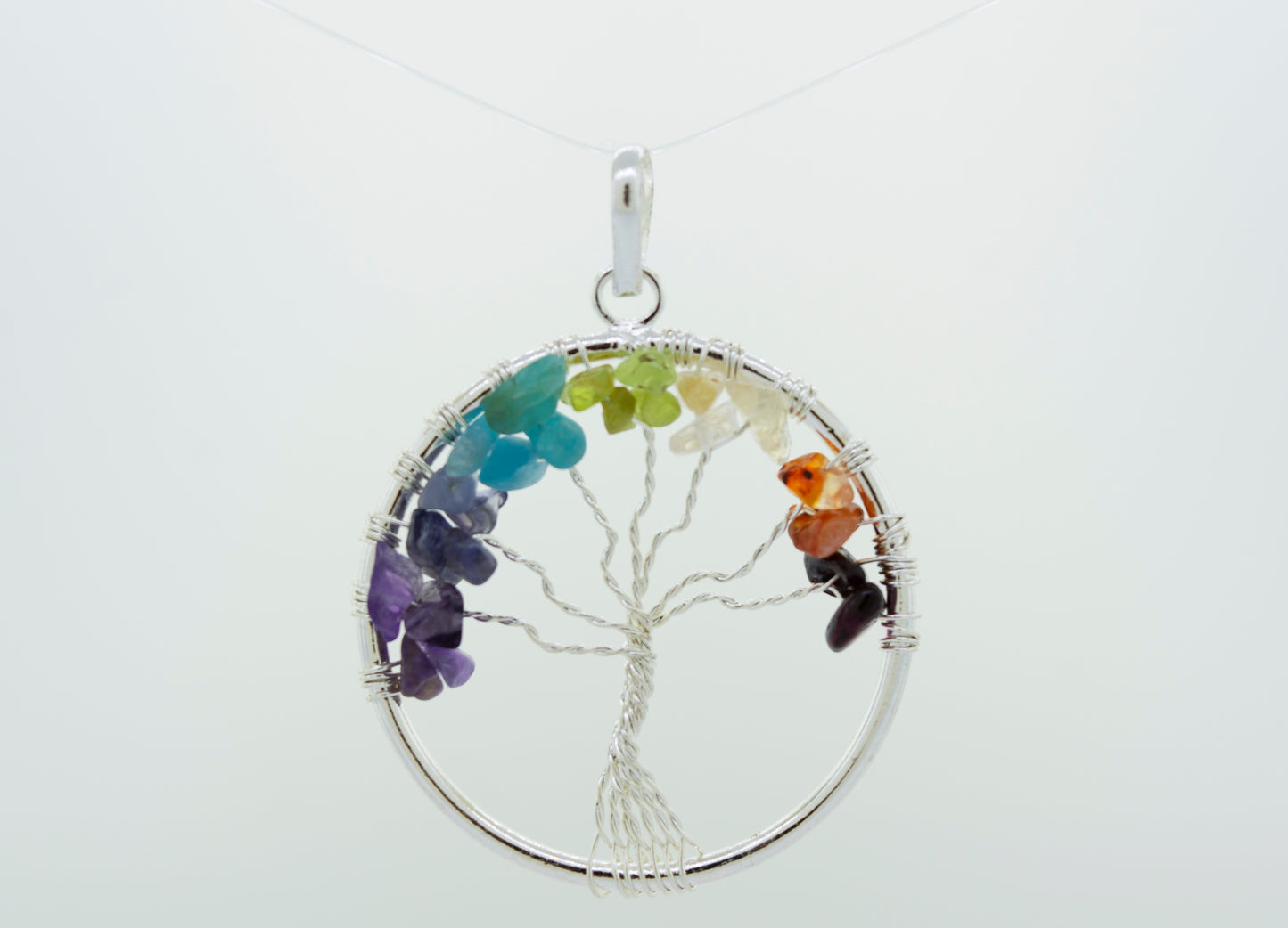 
                  
                    A Super Silver Wire-Wrapped Chakra Tree of Life pendant adorned with chakra stones.
                  
                